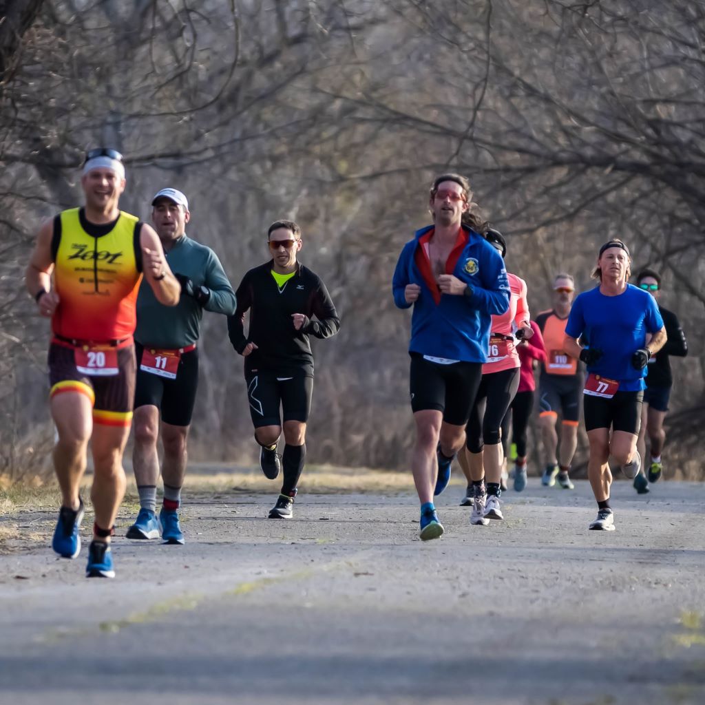 John Bousum (Owasso, OK), Shaun Barrett (Adair, OK), and Joshua Landis (Tulsa, OK) compete in the 
					     2022 Chris Brown Duathlon during the 5K run inside Mohawk Park