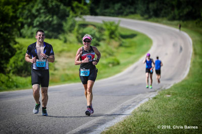 Runners climbimg a hill at the Tulsa Triathlon at Birch Lake